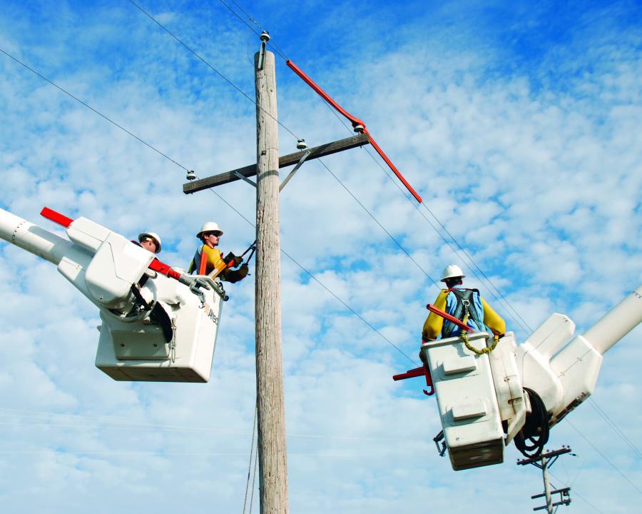 Lineman at work in bucket trucks